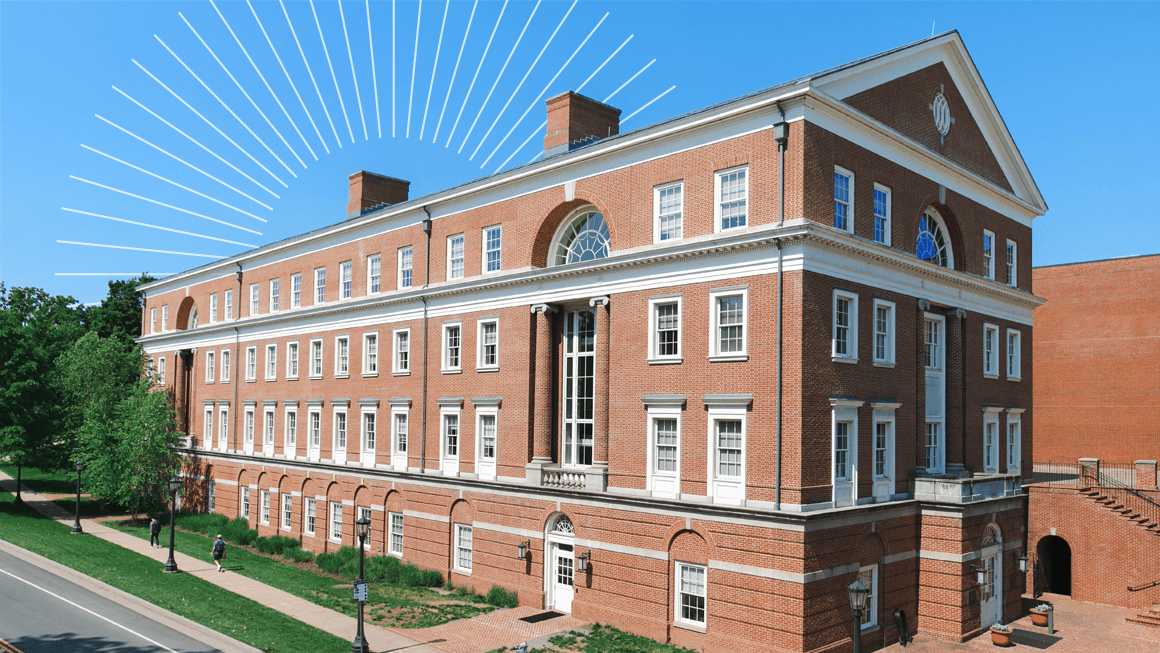 Image of a red brick building against a bright blue sky with a sunburst graphic
