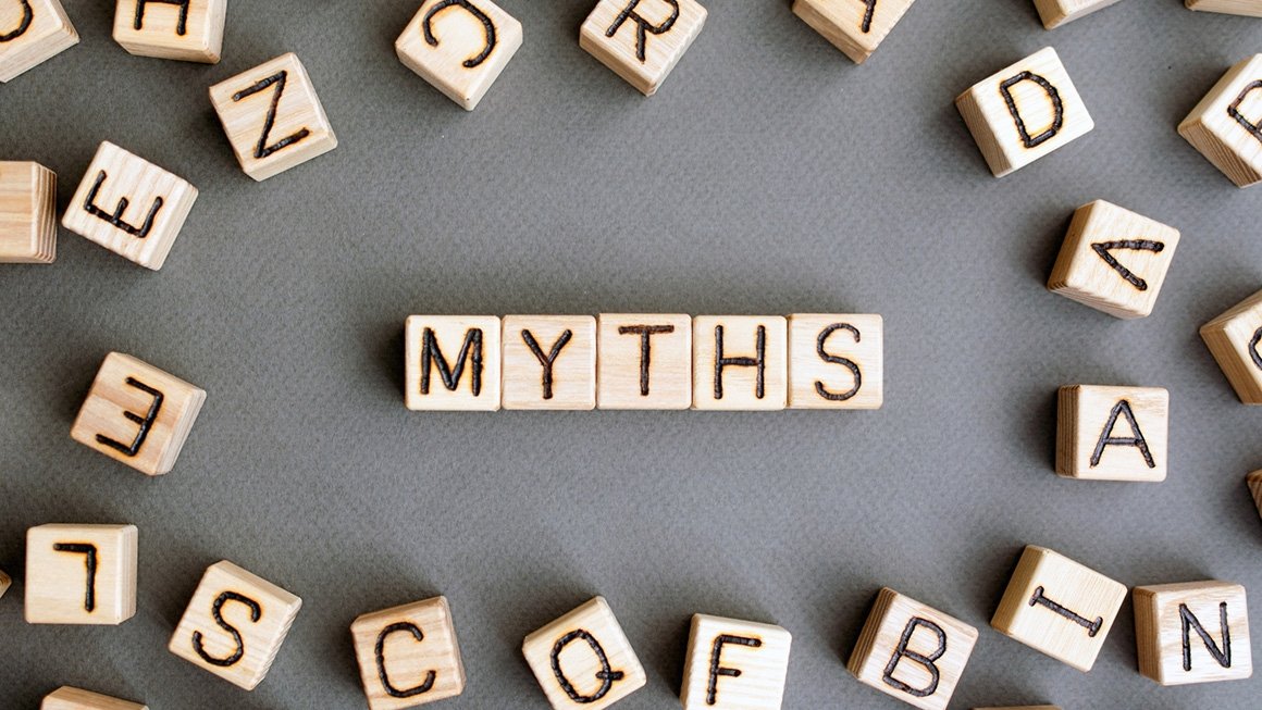 Wooden blocks on a gray background spell out the word "myths"