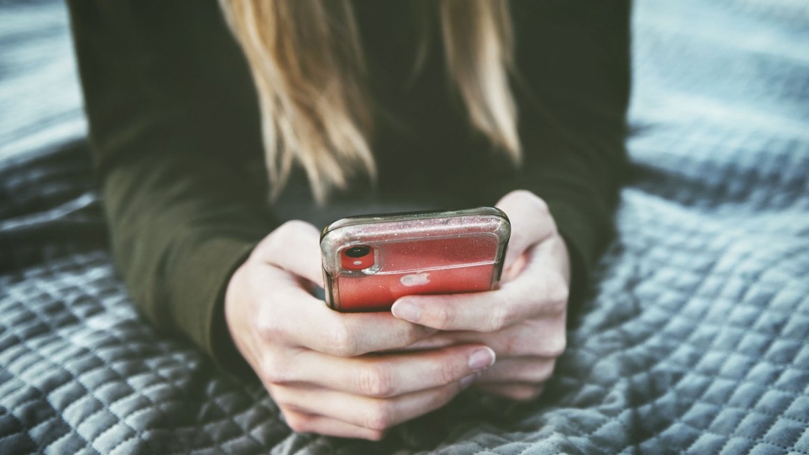 Teen holding smartphone