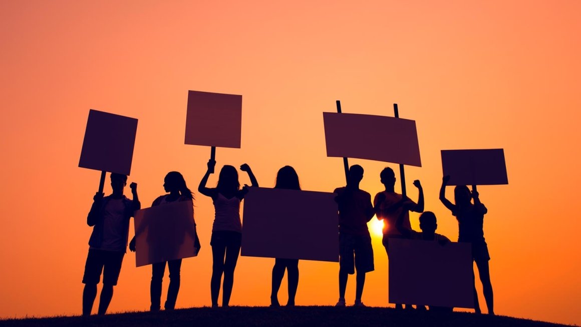 Silhouettes of students holding signs