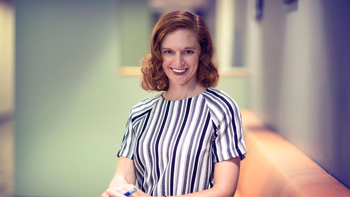 Rachel Wahl smiles at camera wearing a striped shirt