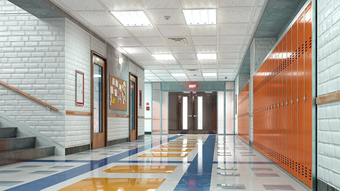 Empty school hallway with orange lockers on the right, steps on the left, and a set of double doors at the end of the hall. Blue and yellow tiles on the floor.