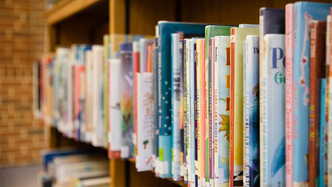 A row of children's books on a shelf