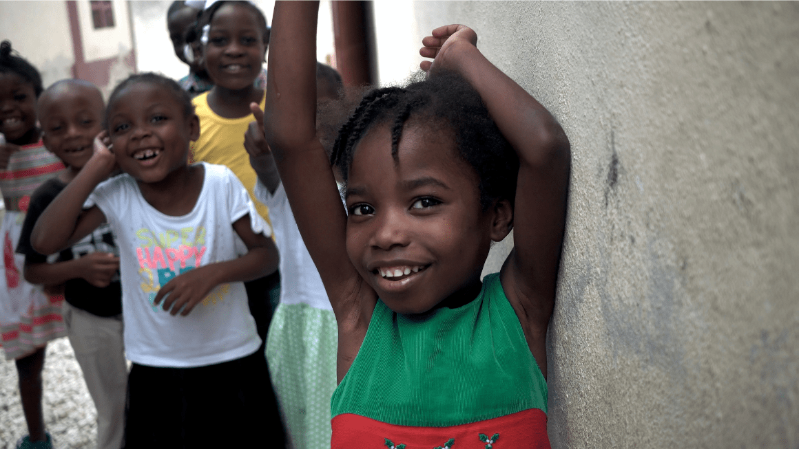 Haitian children smile at the camera