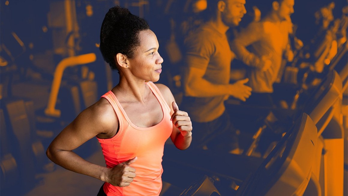 A woman runs on a treadmill in a workout class