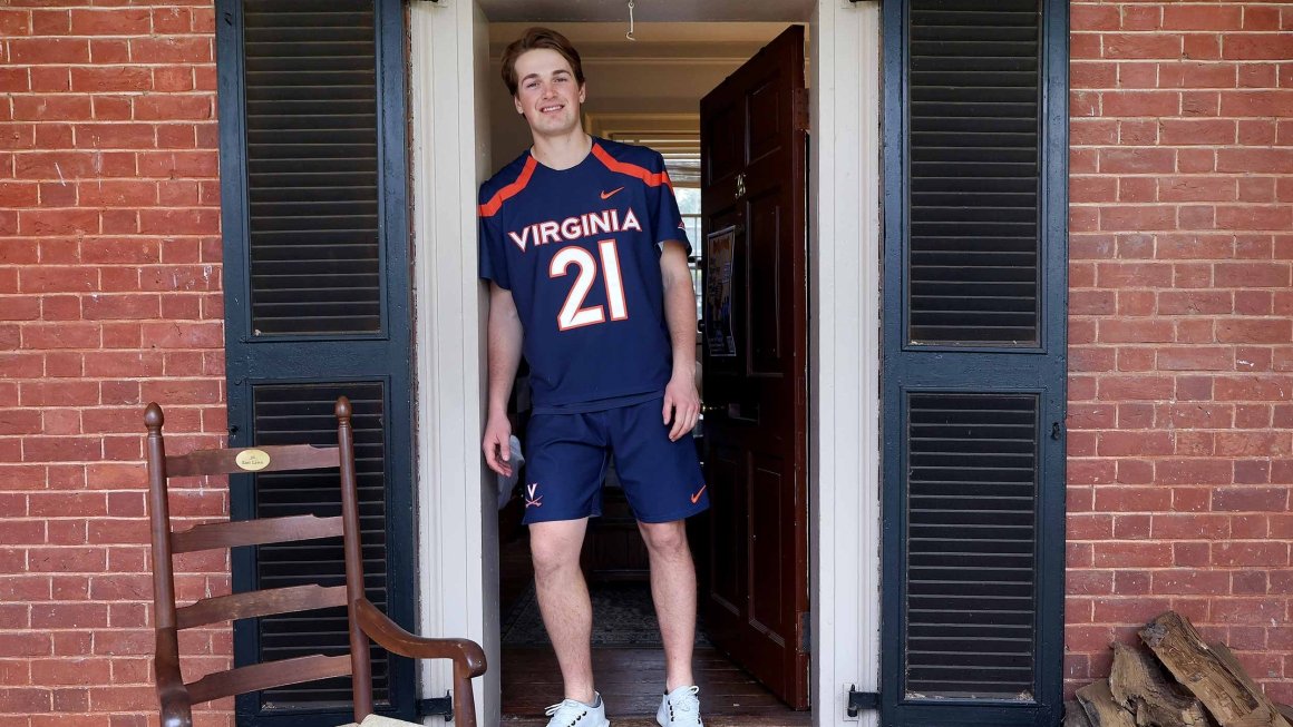 Tommy McNeal stands in the doorway of his room on the UVA lawn.