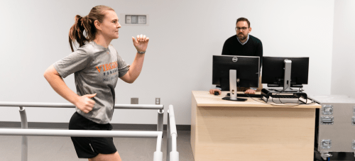 A student running on a treadmill in a kinesiology lab