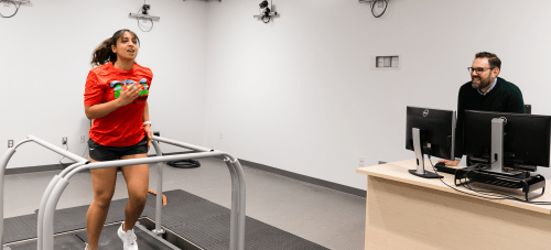 A student running on a treadmill in a kinesiology lab