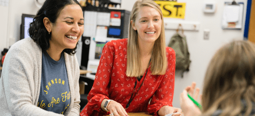 Teachers working with a student at a table