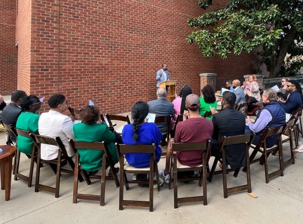 LaRon Scott speaking a group of people at the Hunter Bench Dedication ceremony