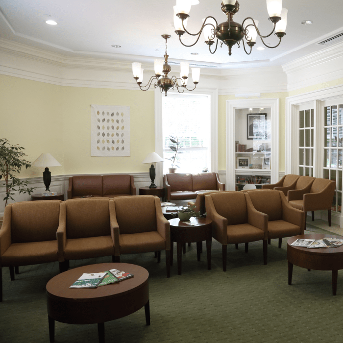 A waiting room with rows of chairs and tables at the Sheila C. Johnson Center
