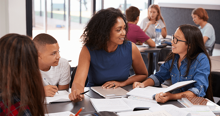 admissions_landingpage_pladmissionsphoto_10-27-2022.png A teacher working with a group of students at a table