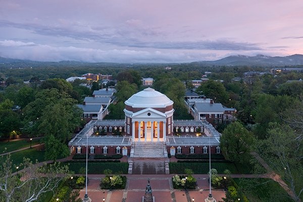 Rotunda photographed from above surrounded by green trees and a purple sky