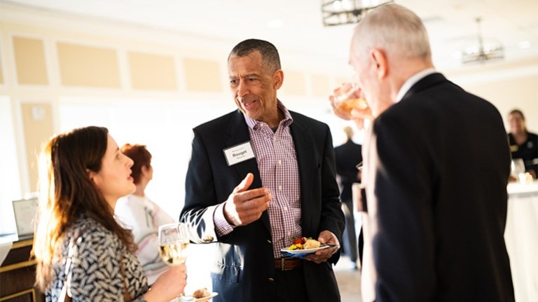 A group of people having a conversation at an event.
