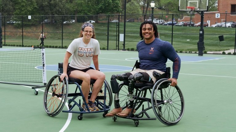 Abby Fines and Brian Douglas sit in wheelchairs next to one another.