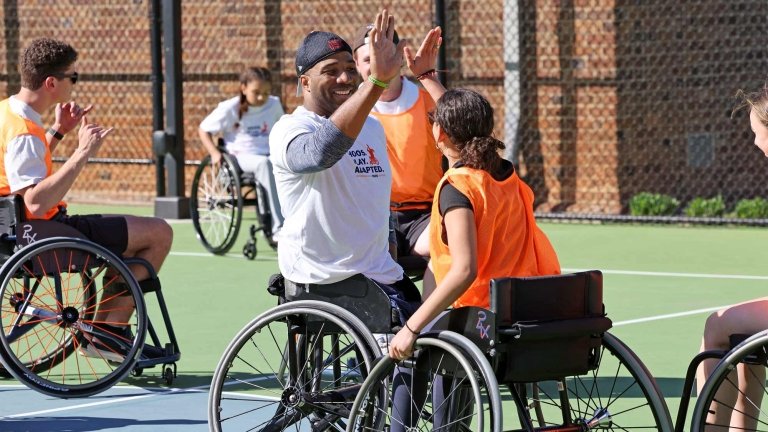 Trevon Jenifer high fiving a team mate during a game of wheelchair basketball